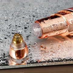detailtrimmer - Nahaufnahme eines roségoldenen elektrischen Trimmerkopfs mit abgenommener Kappe, die auf einer nassen, mit Wassertropfen bedeckten Oberfläche liegt