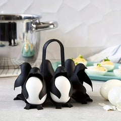 Egg Cooker - Holder with two eggs secured, placed on a kitchen counter near a metal pot and prepared deviled eggs
