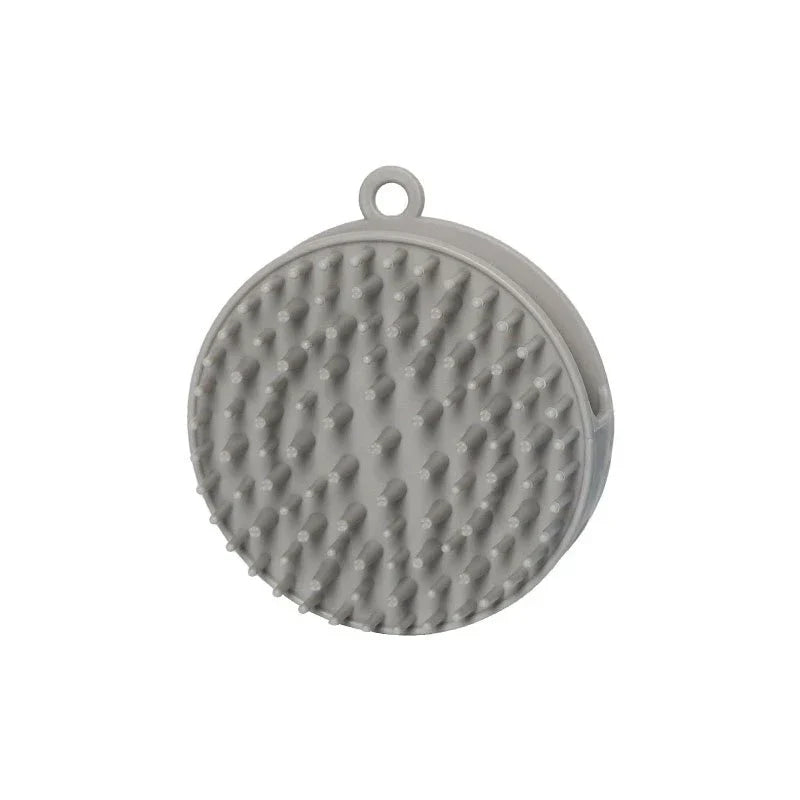 Shampoo Dispenser - Round gray handheld silicone brush with raised soft bristles and hanging loop, shown against a white background.