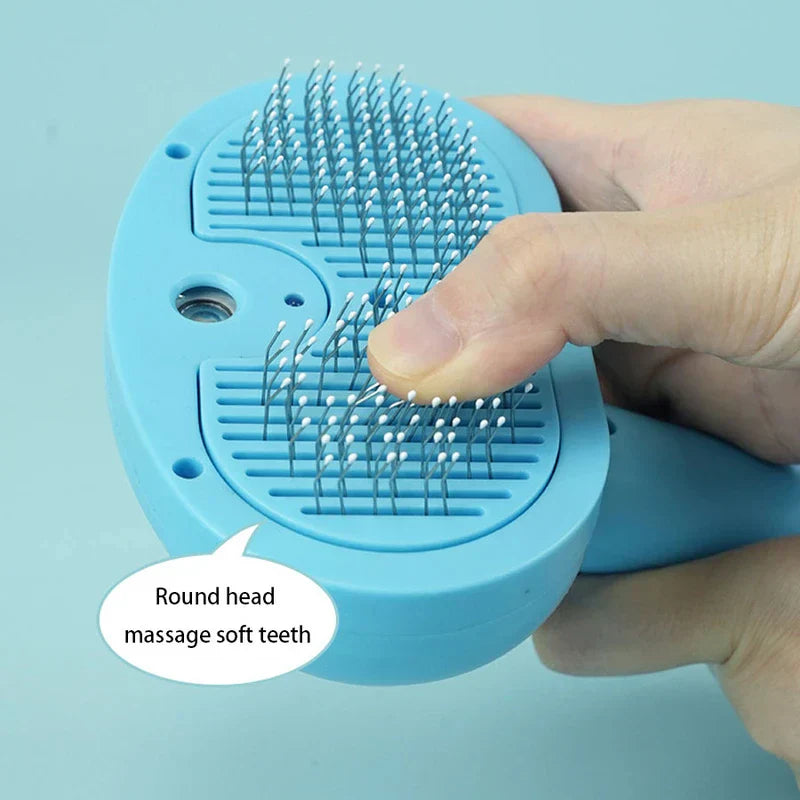 Blue Light Spray Grooming Comb Brush - Close-up of a hand pressing the rounded soft tips of a light blue pet grooming brush's pins.