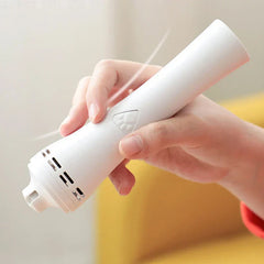 Electric Dog Nail Trimmer - Hand holding a white handheld pet grooming tool, demonstrating the vacuum suction function with visible airflow