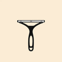Pet Grooming Deshedding Brush - Black Y-shaped plastic tool with a slotted white strip along its horizontal head, against a beige background