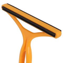 Pet Grooming Deshedding Brush - Close-up partial view of an orange Y-shaped plastic handle tool with double black ridged strips along its head