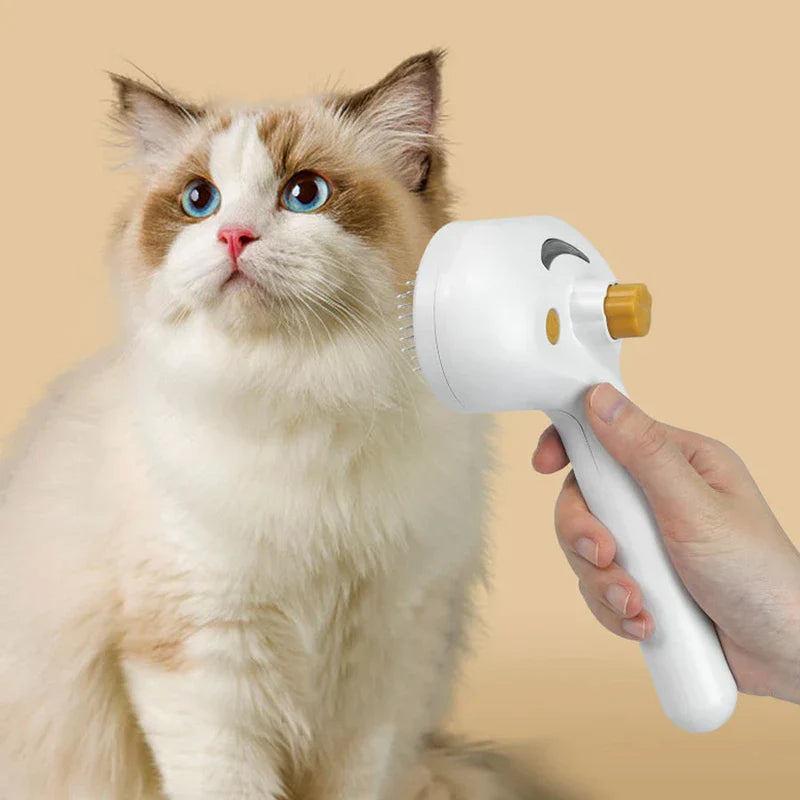 Deshedding Rake - A hand holds a white pet grooming brush near the face of a fluffy blue-eyed cat with light brown and white fur