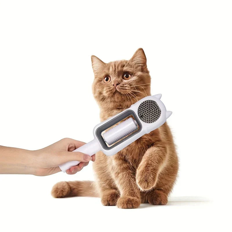 Pet Grooming Brush For Dogs - A hand holding a pet brush beside a seated orange cat with a raised front paw, against a white background