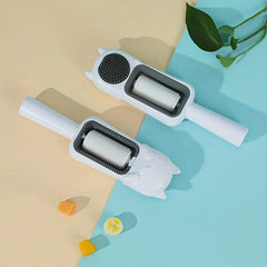Pet Grooming Brush For Dogs - Two white handheld cat-shaped lint roller style tools resting on a split beige and light blue surface, with small decor and a plant leaf in the corner.