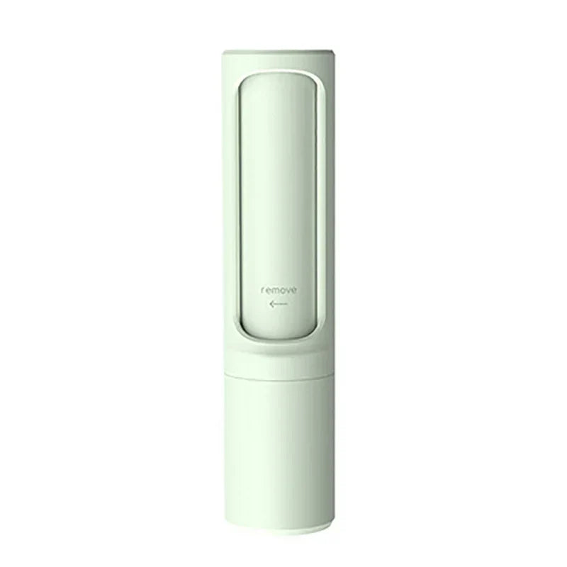 Light green pet hair remover brush with remove marking, displayed on a plain white background