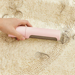 Pet hair remover brush roller held in hand