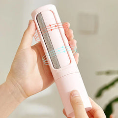 A hand holds an open pink pet hair remover brush, exposing its textured cleaning surface with red and blue directional arrows overlaid.