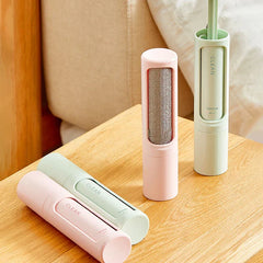 Pet Hair Remover Brush - Pink and green pet hair remover brushes, some showing the textured surface, on a wooden table