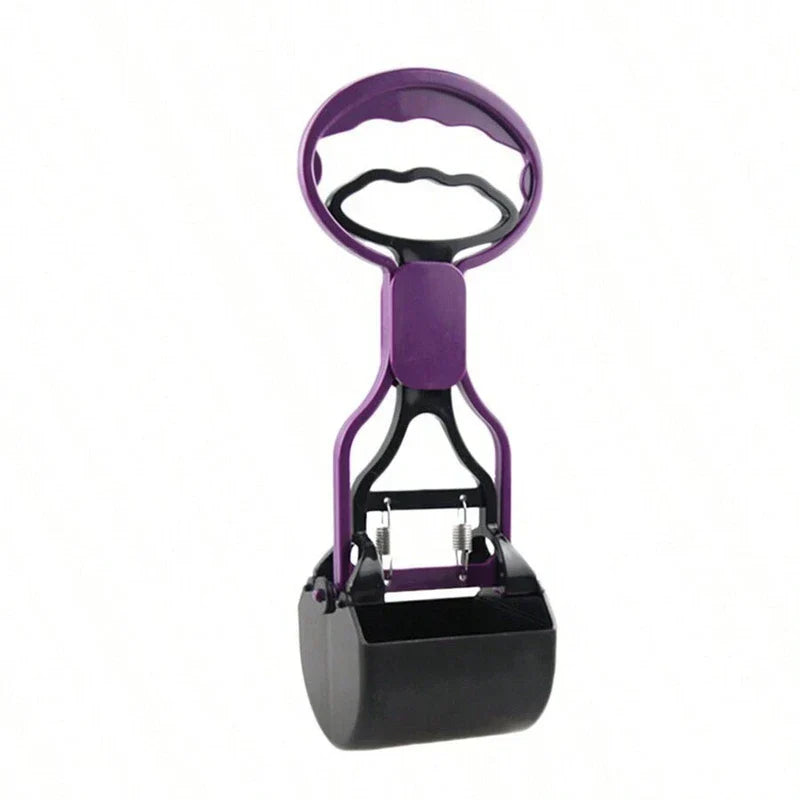 Pet poop scooper jaw grabber tool held over a grassy yard