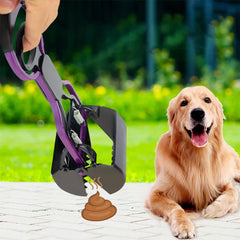 Pet poop scooper jaw grabber tool leaning against a fence