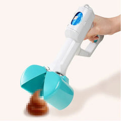 Hand holding an open poop scooper positioned over a pile of pet waste