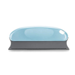 Pet grooming brush with shell design on a white background