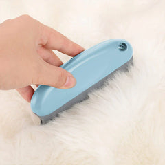 Hand holds light blue dog grooming comb brushing white fluffy fur