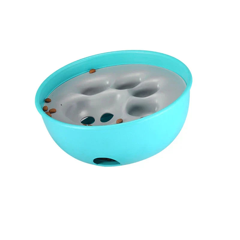 Teal and gray bowl slow feeder with scattered pet kibble on its raised surface, set against a white background