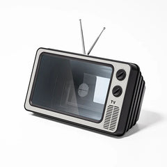 Retro TV-styled phone screen magnifier with dual antennas, control knobs, and speaker grille on white background