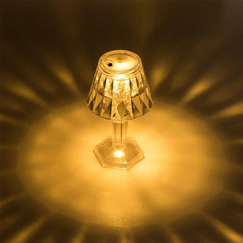 Top view of lit mini led candle lamp projecting warm patterned light onto surrounding surface