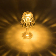 Top view of lit mini led candle lamp projecting warm patterned light onto surrounding surface