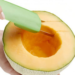 A plastic melon slicer cutting into the flesh of a halved cantaloupe