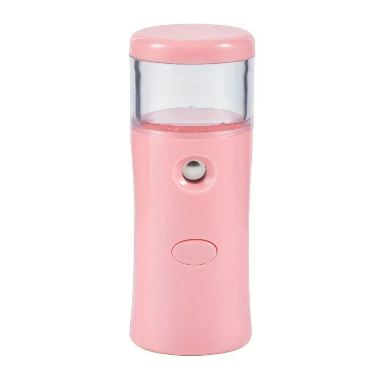 Portable nano facial mist sprayer held near face for hydration
