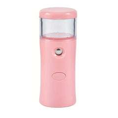 Portable nano facial mist sprayer held near face for hydration