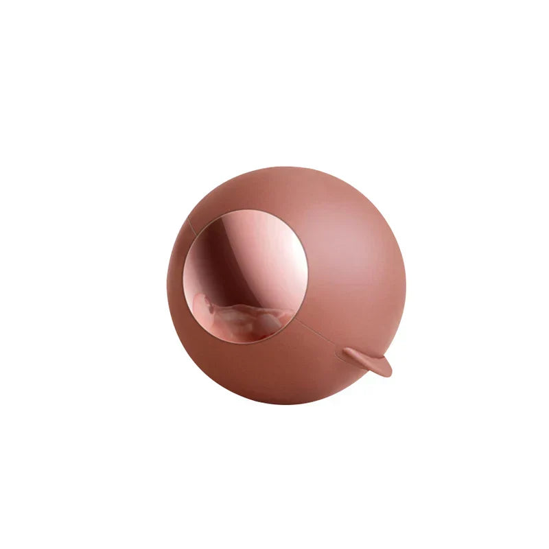 Matte dusty rose spherical lint remover roller with a side tab, front view on a white background