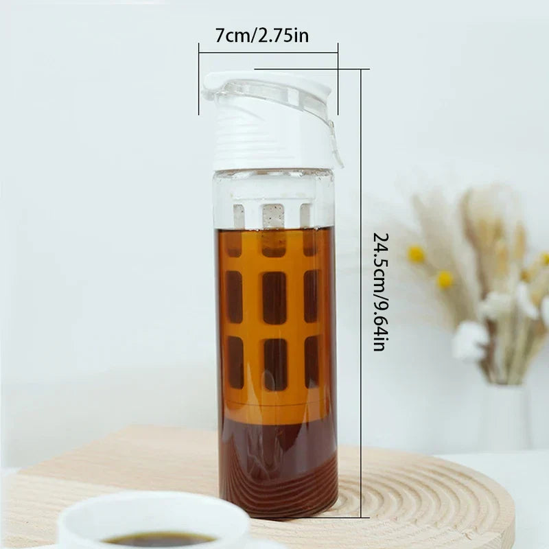 Portable cold brew coffee maker on wooden mat, with size labels: 7cm/2.75in width, 24.5cm/9.64in height, holds brown cold brew