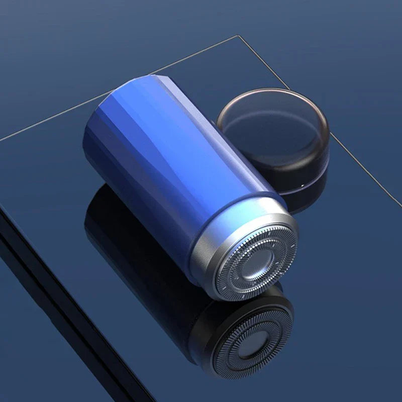 Mini electric shaver held in hand for size comparison