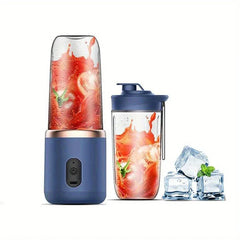 Navy portable personal blender with tomato smoothie inside, matching travel cup, and ice cubes with mint on white background