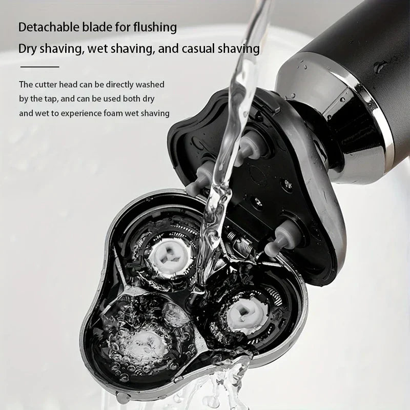 Detached blade head of an electric shaver razor being rinsed under running water, with text about detachable flushing and wet/dry use.