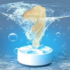 White and blue mini washing machine underwater producing bubbles and a water vortex, with a yellow fabric item suspended above it.