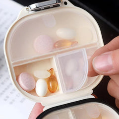 Portable waterproof mini pill box case keychain in hand