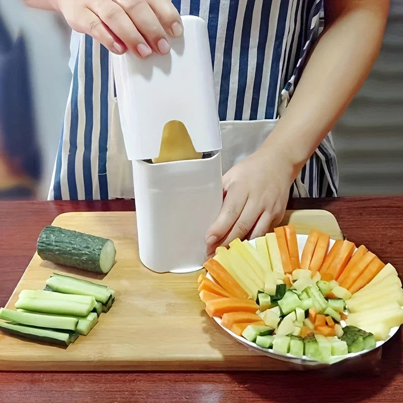 Person pressing down on a white potato french fry cutter over a cutting board, with cut veggies on a plate nearby