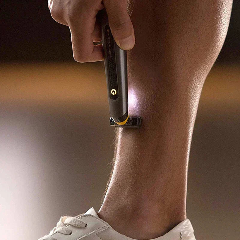 MicroTouch electric trimmer being used to shave leg hair, with built-in LED light illuminating skin