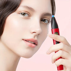 Woman holding a red and black eyelash curler comb near her face against a light pink background