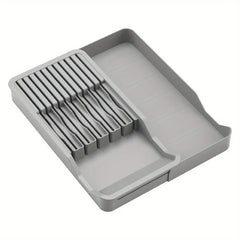 bloque de cuchillos - Organizador gris para cuchillos de cocina con secciones ranuradas para cuchillos y un compartimento abierto para utensilios, vacío.