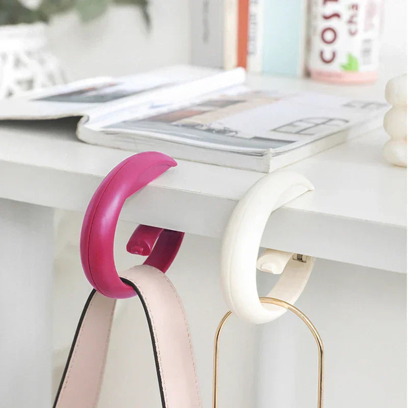 Foldable handbag hook hanger in use with a purse