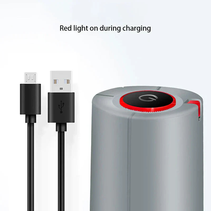 Gray electric water pump dispenser showing red charging indicator light, with a USB-A to Micro-USB charging cable