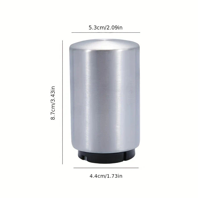 Stainless steel cylindrical beer bottle opener with black base, showing diameter and height measurements in cm and inches on white background
