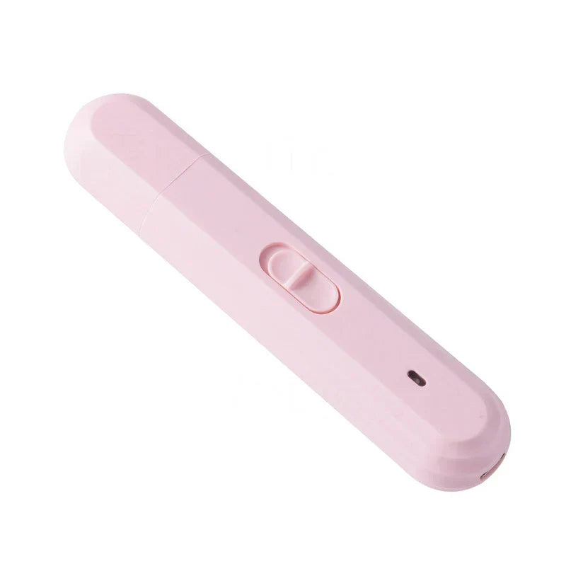 Rechargeable dog cat paw grinding tool held near a pet's paw