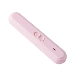 Rechargeable dog cat paw grinding tool held near a pet's paw