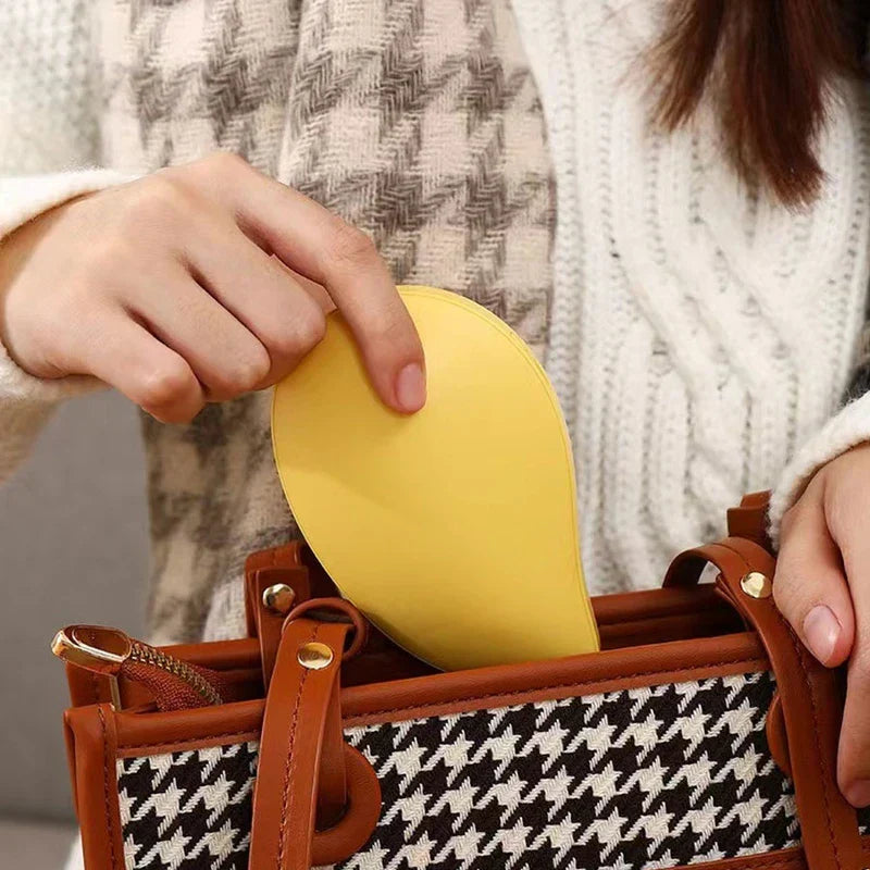 rechargeable hand warmer pocket heater in a coat pocket