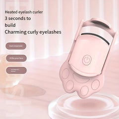 Pink heated eyelash curler with cat paw handle against soft pastel background with feature text labels