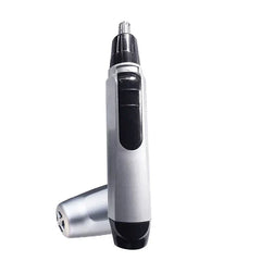Upright silver and black nose ear hair trimmer with its protective cap resting beside it on a white background