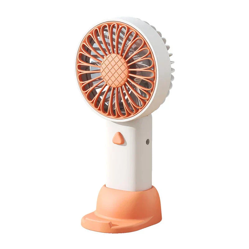 White and orange travel fan displayed against a plain white background, showing handheld design with base stand