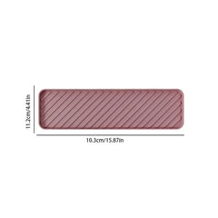 Rosa rechteckige Getränkematte mit diagonalen erhabenen Rillen, 10,3 cm breit und 11,2 cm hoch, auf weißem Hintergrund.