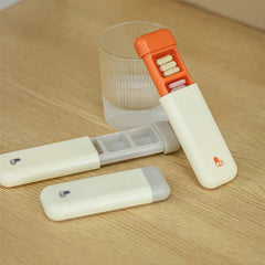 Weekly Pill Organizer - Three weekly pill organizers on wooden table, two open showing pill compartments next to a ribbed glass
