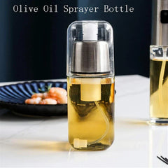 Oil sprayer dispenser filled with yellow liquid, sitting on white counter near a plate of shrimp