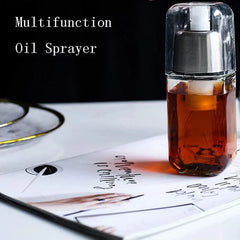Square oil sprayer dispenser holding amber liquid, placed on top of an open magazine